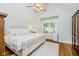 Spacious main bedroom featuring hardwood floors, white accents, and window with shutters at 60 E Poplar St, Zionsville, IN 46077