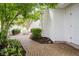 Charming brick patio with lush greenery and a view of the home's exterior at 60 E Poplar St, Zionsville, IN 46077
