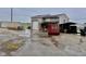 View of the detached garage of this property, including work equipment and a spacious lot in rainy conditions at 613 Anderson Rd, Anderson, IN 46017