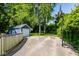 Large backyard with a blue shed, basketball hoop, trees, and open space for outdoor activities at 6264 Central Ave, Indianapolis, IN 46220