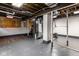 Unfinished basement with exposed beams, painted walls, and a furnace at 6264 Central Ave, Indianapolis, IN 46220