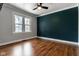 Cozy bedroom with hardwood floors, a ceiling fan, and natural light at 6264 Central Ave, Indianapolis, IN 46220