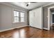 Bedroom with wood floors, a window, gray walls, and a Murphy bed at 6264 Central Ave, Indianapolis, IN 46220