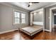Bedroom with wood floors, a window, gray walls, and an open Murphy bed at 6264 Central Ave, Indianapolis, IN 46220