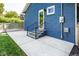 Exterior view of a blue brick house with patio and steps to the back door at 6264 Central Ave, Indianapolis, IN 46220