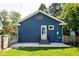 Exterior of blue brick home with patio, steps to back door and fenced yard at 6264 Central Ave, Indianapolis, IN 46220