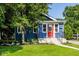 Charming blue home featuring a vibrant red front door and well-maintained landscaping at 6264 Central Ave, Indianapolis, IN 46220