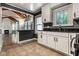 White cabinets and black countertops open to the living room in this updated kitchen space at 6264 Central Ave, Indianapolis, IN 46220