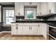 Bright kitchen with white cabinets, dark granite countertops and large windows at 6264 Central Ave, Indianapolis, IN 46220