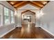 Living room featuring hardwood floors, arched entryway, wood ceilings and natural lighting at 6264 Central Ave, Indianapolis, IN 46220