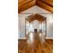 Bright living room featuring a white fireplace, wood floors, and wood-beamed ceilings at 6264 Central Ave, Indianapolis, IN 46220