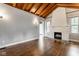 Living room featuring hardwood floors, wood ceiling and a white brick fireplace at 6264 Central Ave, Indianapolis, IN 46220
