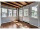 Bright sun room with hardwood floors, wood ceilings and multiple windows at 6264 Central Ave, Indianapolis, IN 46220