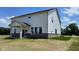 Picture of the back of the house with a covered patio and a large backyard with newly planted grass seed at 6338 Rippling Rock Dr, Plainfield, IN 46168