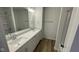 Bathroom featuring double sink vanity with quartz countertop and modern fixtures at 6338 Rippling Rock Dr, Plainfield, IN 46168