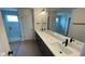 Bathroom featuring double sinks and a walk-in shower with a glass door at 6338 Rippling Rock Dr, Plainfield, IN 46168