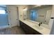 Bathroom with double sinks, a large mirror, and a glass enclosed shower at 6338 Rippling Rock Dr, Plainfield, IN 46168