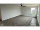Bright bedroom featuring neutral carpet, ceiling fan, and window offering pleasant views and natural light at 6338 Rippling Rock Dr, Plainfield, IN 46168