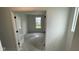 A bedroom viewed through the door, featuring neutral walls and large window allowing ample natural light at 6338 Rippling Rock Dr, Plainfield, IN 46168