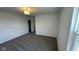 Bright bedroom features neutral carpet, white walls, a closet, and a window for natural light, creating a serene space at 6338 Rippling Rock Dr, Plainfield, IN 46168