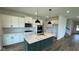 Modern kitchen with island, stainless steel appliances, and beautiful white cabinetry at 6338 Rippling Rock Dr, Plainfield, IN 46168