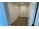 Neat laundry room with wood-style floors and a wire shelf for storage at 6338 Rippling Rock Dr, Plainfield, IN 46168