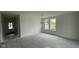 Bright room with ample light from the big windows and a modern chandelier fixture at 6338 Rippling Rock Dr, Plainfield, IN 46168