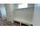 Practical mudroom with built-in bench, hooks, and storage, seamlessly blending functionality with stylish design at 6338 Rippling Rock Dr, Plainfield, IN 46168