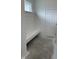Mudroom featuring white board and batten, built-in bench, and a door leading to the exterior at 6338 Rippling Rock Dr, Plainfield, IN 46168