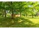 Green backyard featuring large shade trees and healthy lawn at 6498 N County Road 475 E, Pittsboro, IN 46167