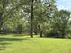 Lush green backyard with mature trees creating a serene and private outdoor space at 6498 N County Road 475 E, Pittsboro, IN 46167