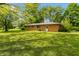 Brick home exterior, with shaded backyard and mature trees at 6498 N County Road 475 E, Pittsboro, IN 46167
