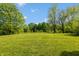 Wide shot of green backyard offering plenty of space and mature trees at 6498 N County Road 475 E, Pittsboro, IN 46167
