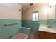 Bathroom featuring a tub, a wood vanity and green tile walls at 6498 N County Road 475 E, Pittsboro, IN 46167