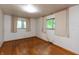Bedroom featuring hardwood floors, neutral walls, and natural light from two windows at 6498 N County Road 475 E, Pittsboro, IN 46167