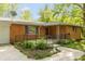 Inviting brick home showcasing a cozy front porch and landscaped garden, creating a warm and welcoming atmosphere at 6498 N County Road 475 E, Pittsboro, IN 46167
