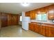Classic kitchen with wood cabinets, white appliances, and a functional layout at 6498 N County Road 475 E, Pittsboro, IN 46167