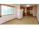 Spacious eat-in kitchen with white appliances, wood cabinets, and a large window for natural light at 6498 N County Road 475 E, Pittsboro, IN 46167