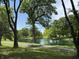 Scenic view of a tranquil pond surrounded by lush trees and greenery, perfect for a relaxing retreat at 6498 N County Road 475 E, Pittsboro, IN 46167