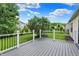 Wood deck with black railings overlooking a well-manicured backyard and lush green grass at 7061 Blankenship Ave, Indianapolis, IN 46217