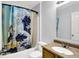 Bathroom featuring a tub with shower, a vanity, and a mirror at 7061 Blankenship Ave, Indianapolis, IN 46217