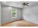 This bedroom features a ceiling fan, a window with outside view, and wood flooring at 7061 Blankenship Ave, Indianapolis, IN 46217