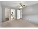 A roomy carpeted bedroom with a view into the bathroom, a neutral wall and a ceiling fan at 7061 Blankenship Ave, Indianapolis, IN 46217