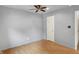 Bedroom with a ceiling fan, wood flooring, light gray walls, and white door at 7061 Blankenship Ave, Indianapolis, IN 46217