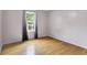 A well lit bedroom with a window, gray walls and light wood floors at 7061 Blankenship Ave, Indianapolis, IN 46217
