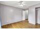 A spacious bedroom with wood floors, neutral walls, and a ceiling fan for comfort at 7061 Blankenship Ave, Indianapolis, IN 46217