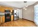 Eat-in kitchen featuring stainless steel appliances, granite countertops, natural wood cabinets, and laminate floors at 7061 Blankenship Ave, Indianapolis, IN 46217