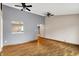 Open living room with wood floor and passthrough to kitchen at 7061 Blankenship Ave, Indianapolis, IN 46217