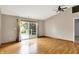 Open living space with wood flooring, sliding glass doors to deck, and ceiling fan at 7061 Blankenship Ave, Indianapolis, IN 46217