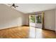 Open living room with hardwood floors and sliding door to back porch at 7061 Blankenship Ave, Indianapolis, IN 46217